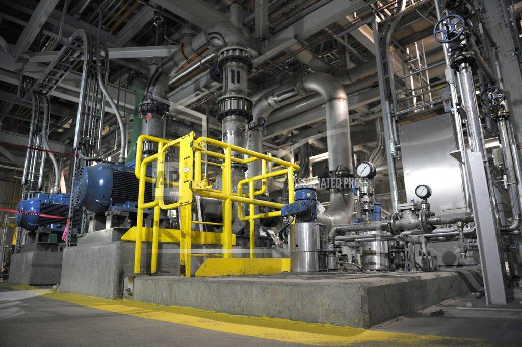 Michael Bell FILE - In this Oct. 2, 2014, file photo, pipes and tanks snake around the inside of a carbon capture and storage facility during the official opening of the facility at the Boundary Dam Power Station in Estevan, Saskatchewan. Boundary Dam has the only currently operational power plant-to-oilfield pipeline for carbon capture in North America. The U.S. government under Donald Trump's administration has approved routes for a system of pipelines that would move carbon dioxide across Wyoming in what could be by far the largest such network in North America, if developed. (Michael Bell/The Canadian Press, via AP, File)