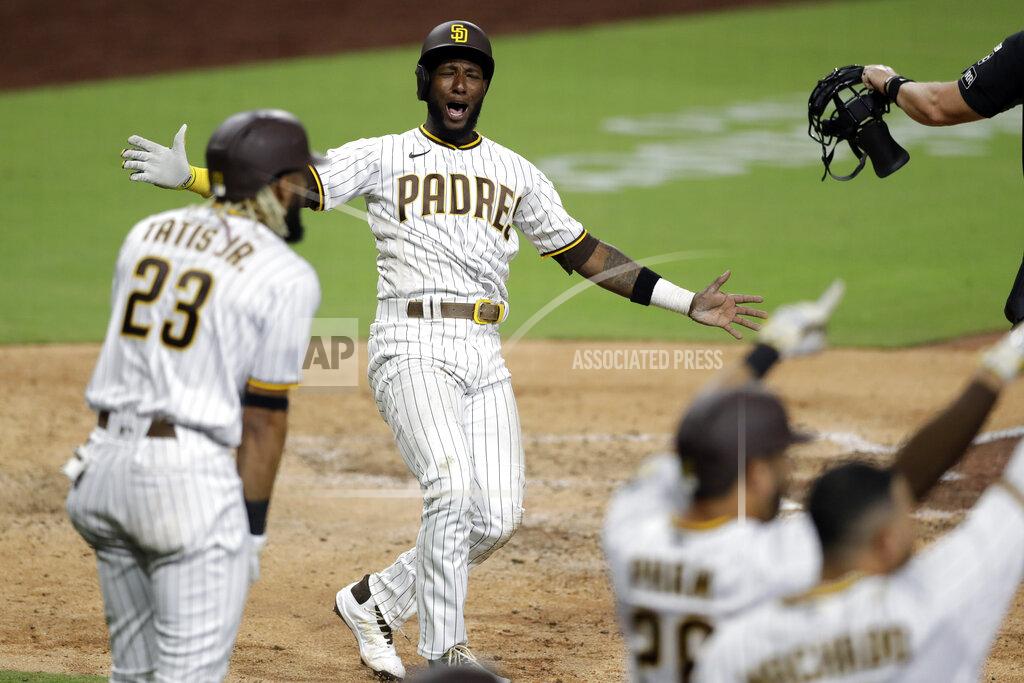 Gregory Bull San Diego Padres' Jurickson Profar, second from left, celebrates after scoring off a three-RBI double by Eric Hosmer during the seventh inning of a baseball game against the Arizona Diamondbacks, Friday, July 24, 2020, in San Diego. (AP Photo/Gregory Bull)