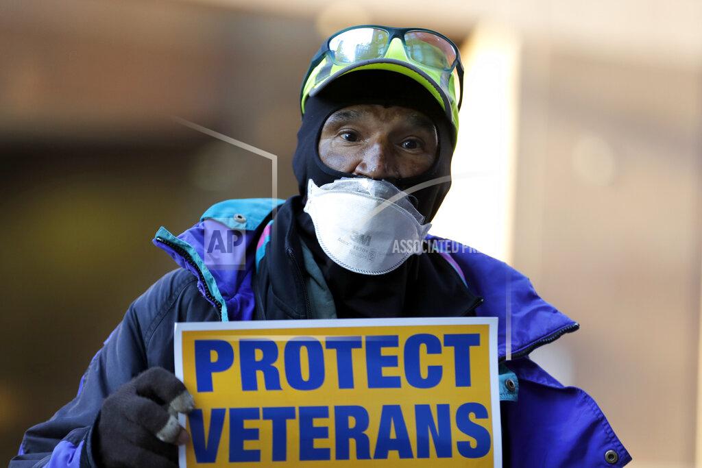 Julio Cortez Clarence Shields, an Army veteran, pickets with a small group of activists from the American Federation of Government Employees local 424 and the National Association of Government Employees local R3-19 during the coronavirus pandemic, outside the Baltimore VA Medical Center, Wednesday, April 22, 2020, in Baltimore. The Department of Veterans Affairs is struggling with shortages of workers at its health care facilities as it cares for veterans infected with the novel coronavirus. (AP Photo/Julio Cortez)