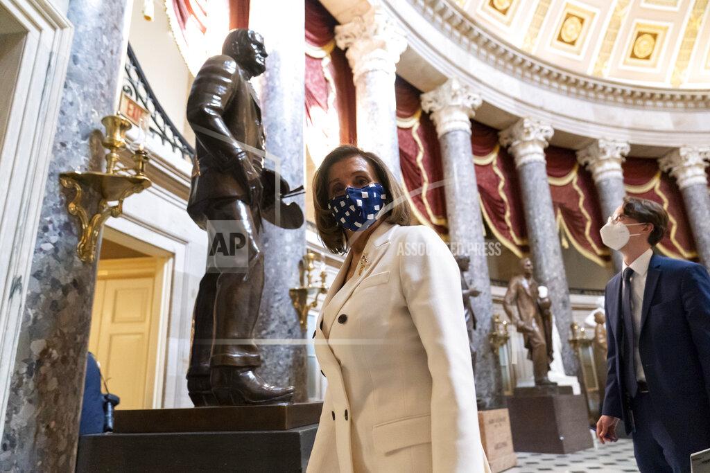 Alex Brandon House Speaker Nancy Pelosi of Calif., walks through Statuary Hall, during the vote on the Democrat's $1.9 trillion COVID-19 relief bill, on Capitol Hill, Wednesday, March 10, 2021, in Washington. (AP Photo/Alex Brandon)