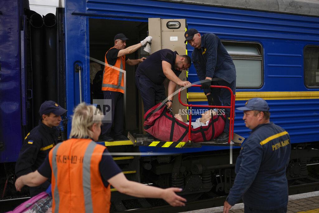 Francisco Seco A man fleeing from shelling boards an evacuation train in a soft stretcher at the train station in Pokrovsk, eastern Ukraine, eastern Ukraine, Saturday, May 28, 2022. Fighting has raged around Lysychansk and neighbouring Sievierodonetsk, the last major cities under Ukrainian control in Luhansk region. (AP Photo/Francisco Seco)