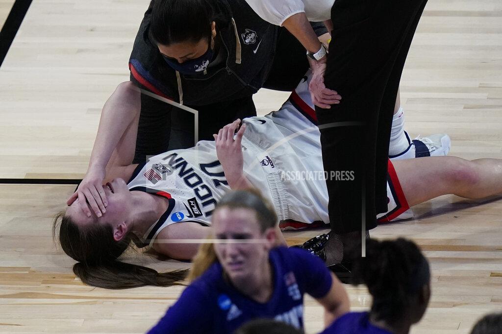 UConn guard Nika Muhl (10) reacts after she was injured during the first half of a college basketball game against High Point in the first round of the women's NCAA tournament at the Alamodome in San Antonio, Sunday, March 21, 2021. (AP Photo/Eric Gay)