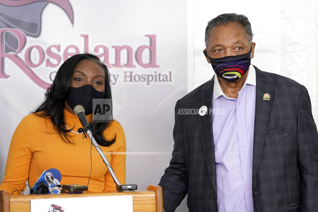 Charles Rex Arbogast FILE - In this Jan. 8, 2021, file photo, Kizzmekia Corbett, left, an immunologist with the Vaccine Research Center at the National Institute of Health, and the Rev. Jesse Jackson, respond to questions after Jackson received his first COVID-19 vaccine at the Roseland Community Hospital in Chicago. Corbett, a Black U.S. government scientist who helped develop Moderna's vaccine, acknowledges ''centuries of medical injustice'' against Black Americans but said COVID-19 vaccines resulted from years of solid research. Trust in those vaccines, she said, is needed to save lives. (AP Photo/Charles Rex Arbogast, File)