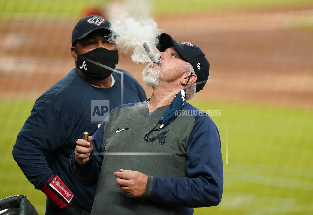Brynn Anderson The Atlanta Braves pitching coach Rick Kranitz lights a cigar in celebration after a baseball game to clinch the NL East title against the Miami Marlins on Tuesday, Sept. 22, 2020, in Atlanta. (AP Photo/Brynn Anderson)
