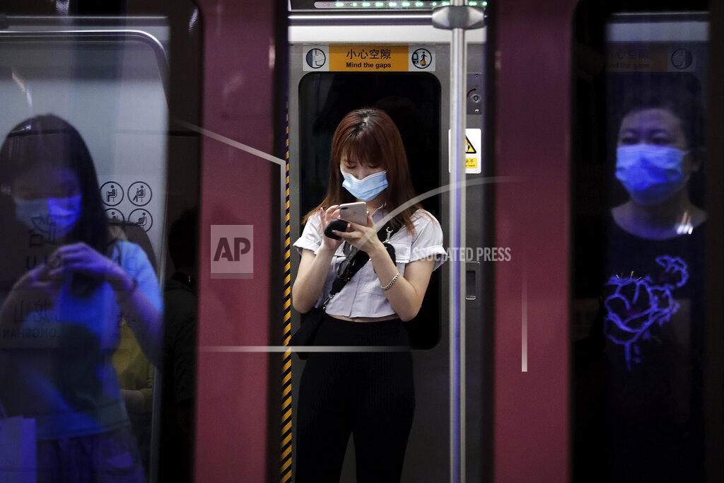 Andy Wong Commuters wearing face masks to protect against the new coronavirus ride in a subway train in Beijing, Wednesday, July 29, 2020. China reported more than 100 new cases of COVID-19 on Wednesday as the country continues to battle an outbreak in Xinjiang. (AP Photo/Andy Wong)