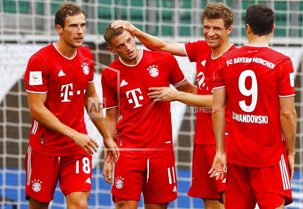 Kai Pfaffenbach Munich's scorer Mickael Cuisance, second left, and his teammates celebrate their side's second goal during the German Bundesliga soccer match between VfL Wolfsburg and FC Bayern Munich in Wolfsburg, Germany, Saturday, June 27, 2020. (Kai Pfaffenbach/Pool Photo via AP)