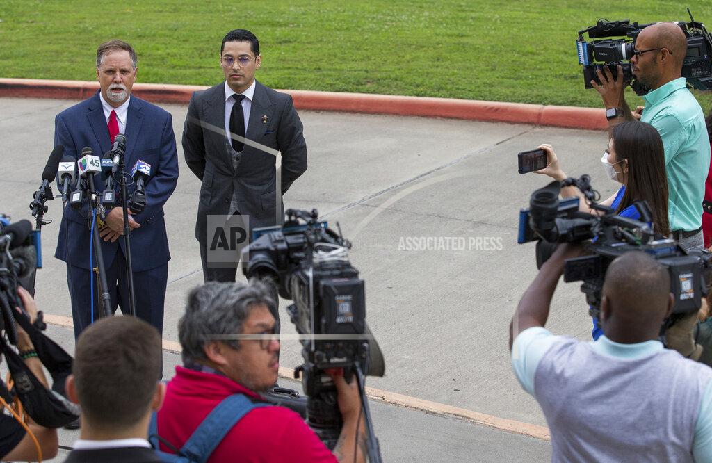 Godofredo A. Vásquez Victor Hugo Cuevas, a 26-year-old linked to a missing tiger named India, and his attorney Michael Elliott, left, talk to reporters before entering Fort Bend County Justice Center for a bond revocation hearing on a separate murder charge, on Friday, May 14, 2021, in Richmond, Texas. (Godofredo A. Vásquez/Houston Chronicle via AP)