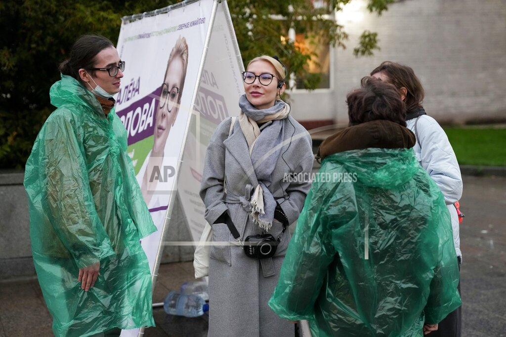 Pavel Golovkin Alyona Popova, the democratic Yabloko party candidate for the State Duma, center, is surrounded by her campaign's team members, during a meeting with voters in Moscow, Russia, Friday, Sept. 3, 2021. One of the country’s most ardent feminists, Popova has fought for years without success to get members of the State Duma to draft legislation to protect women. So she decided to run herself in the Sept. 19 election. (AP Photo/Pavel Golovkin)