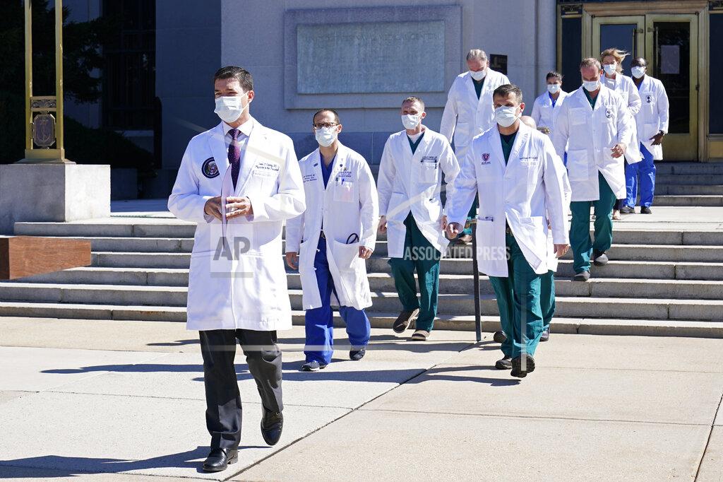 Dr. Sean Conley, physician to President Donald Trump, is followed by a team of doctors for a briefing with reporters at Walter Reed National Military Medical Center in Bethesda, Md., Saturday, Oct. 3, 2020. Trump was admitted to the hospital after contracting the coronavirus. (AP Photo/Susan Walsh)