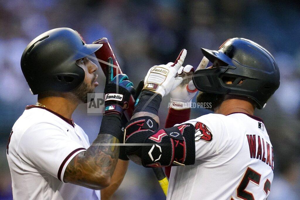 Ross D. Franklin Arizona Diamondbacks' Christian Walker, right, celebrates his home run against the Kansas City Royals with teammate David Peralta, left, during the first inning of a baseball game Monday, May 23, 2022, in Phoenix. (AP Photo/Ross D. Franklin)