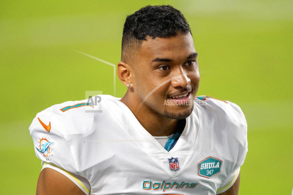 Doug Murray FILE - This Oct. 18, 2020, file photo shows Miami Dolphins quarterback Tua Tagovailoa (1) on the sidelines before playing for the first time against the New York Jets during an NFL football game, in Miami Gardens, Fla. Tagovailoa’s winning personality helped the Miami Dolphins avoid locker room backlash when he was promoted to replace popular veteran Ryan Fitzpatrick. (AP Photo/Doug Murray, File)