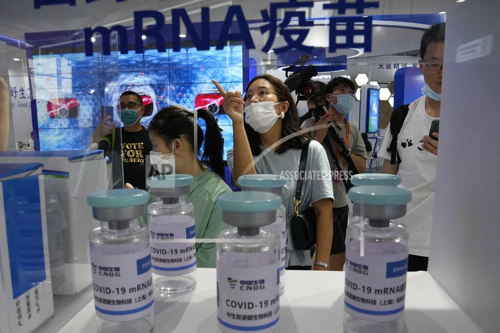 Ng Han Guan Visitors look at giant replica bottles of COVID-19 vaccine including ones produced via mRNA technology by Sinopharm subsidiary CNBG at the China International Fair for Trade in Services (CIFTIS) in Beijing, China on Sept. 5, 2021. More than two years into the pandemic, China has not approved the more effective mRNA vaccines, instead choosing to pursue its own route on COVID-19 vaccines. (AP Photo/Ng Han Guan)