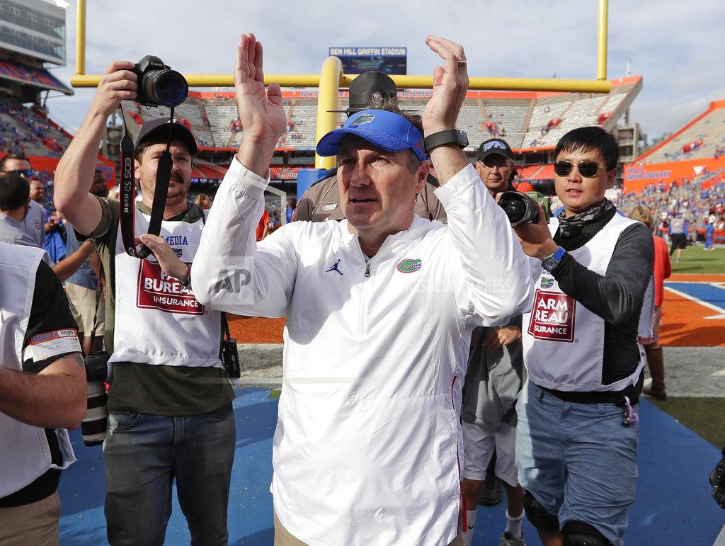 John Raoux Florida head coach Dan Mullen, center, applauds fans as he leaves the field after defeating South Carolina in an NCAA college football game, Saturday, Nov. 10, 2018, in Gainesville, Fla. (AP Photo/John Raoux)