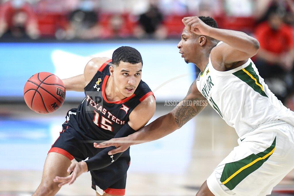 Justin Rex Texas Tech's Kevin McCuller (15) attempts to drive the ball around Baylor's Mark Vital (11) during the first half of an NCAA college basketball game in Lubbock, Texas, Saturday, Jan. 16, 2021. (AP Photo/Justin Rex)