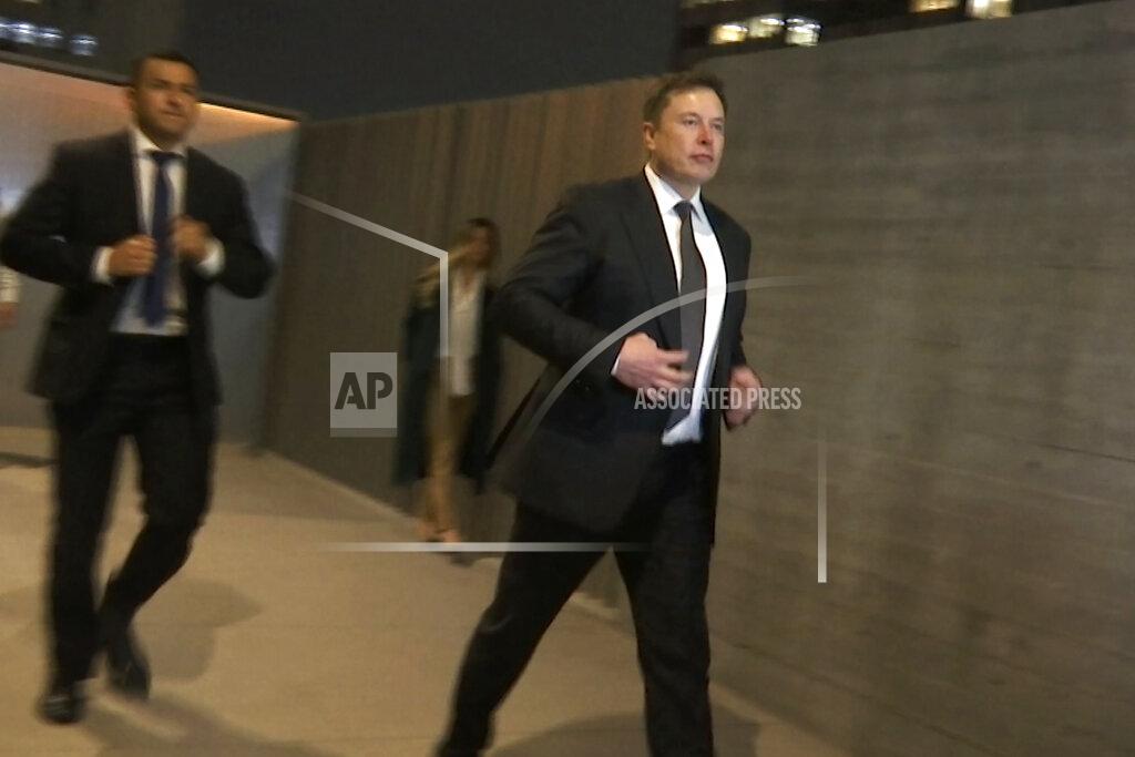 In this frame grab from video, Tesla CEO Elon Musk leaves court, Tuesday, Dec. 3, 2019, in Los Angeles. Musk denied that he meant to call a British cave diver a pedophile when he dubbed him