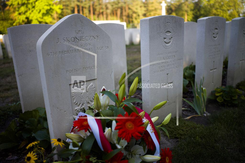Markus Schreiber File - In this Sunday, Sept. 1, 2019 file photo, flowers stand in front of the grave of a fallen Polish soldier after a wreath laying ceremony to commemorate the Nazi-German invasion of Poland and the beginning of WWII, 80-years ago, at the British War Cemetery in Berlin, Germany. A memorial in Berlin to the Polish victims of World War II has moved a step closer to realization, and Germany's foreign minister said Wednesday that construction should start during the next German parliament's four-year term. Nazi Germany invaded Poland in 1939 and subjected its population to more than five years of brutal occupation. Around 3 million of the country's 3.3 million Jews were murdered, as were more than 2 million other mostly Christian Poles. (AP Photo/Markus Schreiber, File)
