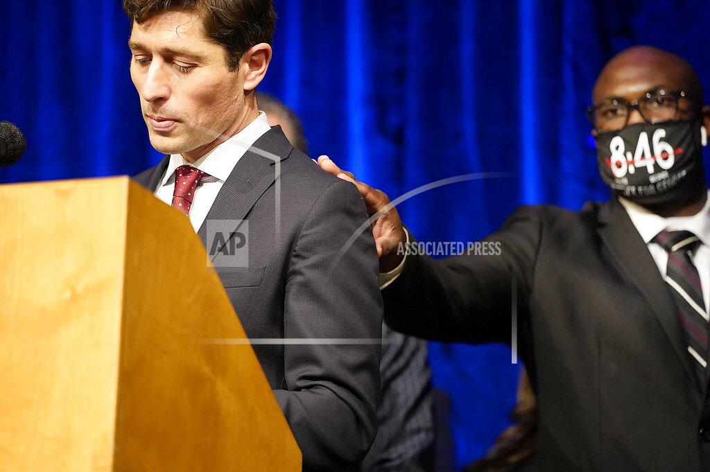 David Joles Philonise Floyd, George's brother, placed his hand on the shoulder of Minneapolis mayor Jacob Frey as Frey walked to the podium to speak during a press conference to announce a $27 million civil lawsuit settlement between the Floyd family and the City of Minneapolis Friday, March 12, 2021, in Minneapolis. (David Joles/Star Tribune via AP)