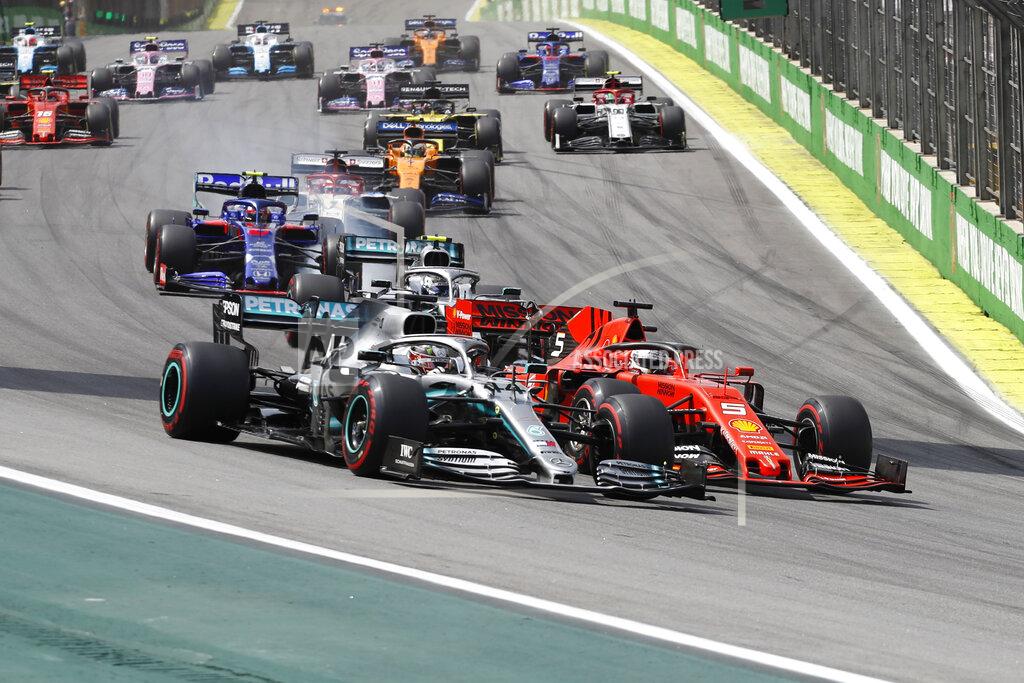 Nelson Antoine Mercedes driver Lewis Hamilton, of Britain, front left, and Ferrari driver Sebastian Vettel, of Germany, steer theirs cars during the Brazilian Formula One Grand Prix at the Interlagos race track in Sao Paulo, Brazil, Sunday, Nov. 17, 2019. (AP Photo/Nelson Antoine)