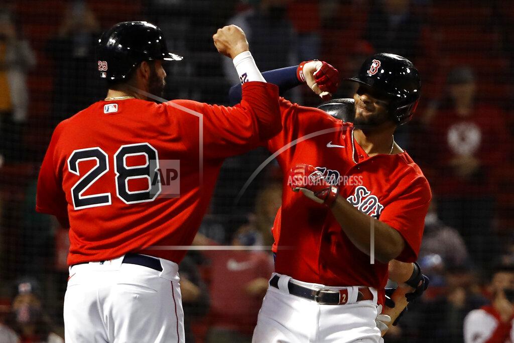Winslow Townson Boston Red Sox's Xander Bogaerts is congratulated by teammate J.D. Martinez after his three-run home run against the Toronto Blue Jays during the fourth inning of a baseball game Tuesday, April 20, 2021, at Fenway Park in Boston. (AP Photo/Winslow Townson)