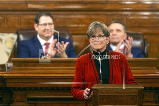 Gov. Laura Kelly is applauded as she begins addressing the Kansas Legislature for the annual State of the State, Tuesday, Jan. 11, 2022, in Topeka, Kan. Democratic and Republican governors are taking vastly different approaches to addressing the ongoing pandemic in their state of the state speeches. (Evert Nelson/The Topeka Capital-Journal via AP)