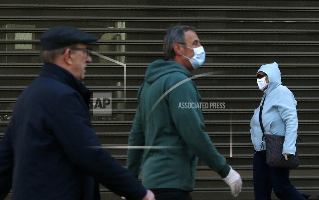 Darko Vojinovic People wearing a mask against the spread of the new coronavirus walk during a curfew in downtown Belgrade, Serbia, Tuesday, April 21, 2020. Serbia's elderly on Tuesday ventured outside their homes for the first time in more than a month as the authorities eased some of the strict measures that have been in place against the new coronavirus. Serbia has introduced some of the toughest rules in Europe as part of efforts to curb the spread of the virus. (AP Photo/Darko Vojinovic)