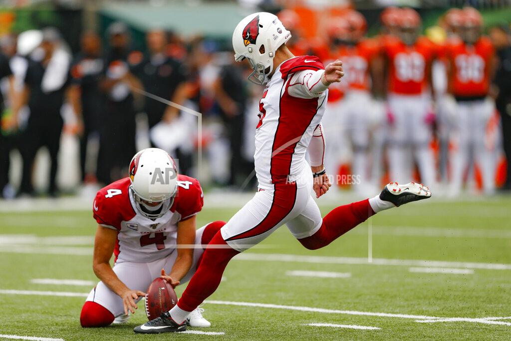 Gary Landers Arizona Cardinals kicker Zane Gonzalez (5) boots an extra point alongside placeholder Andy Lee (4) in the first half of an NFL football game against the Cincinnati Bengals, Sunday, Oct. 6, 2019, in Cincinnati. (AP Photo/Gary Landers)