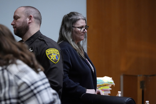 Jennifer Crumbley waits to be escorted from the Oakland County courtroom Friday, Feb. 2, 2024, in Pontiac, Mich. Crumbley, 45, is charged with involuntary manslaughter. Prosecutors say she and her husband were grossly negligent and could have prevented the four deaths if they had tended to their son&rsquo;s mental health. They&rsquo;re also accused of making a gun accessible at home. (AP Photo/Carlos Osorio, Pool)