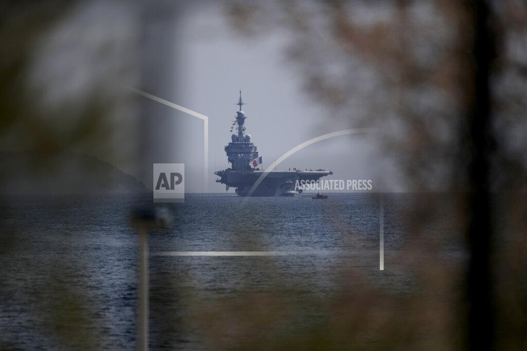 Daniel Cole The French aircraft carrier Charles de Gaulle arrives in the bay of Toulon, southern France, Sunday April 12, 2020. The Defense Ministry said in a statement that around 40 sailors showed symptoms compatible with COVID-19, the disease the coronavirus causes. The new coronavirus causes mild or moderate symptoms for most people, but for some, especially older adults and people with existing health problems, it can cause more severe illness or death. (AP Photo/Daniel Cole)