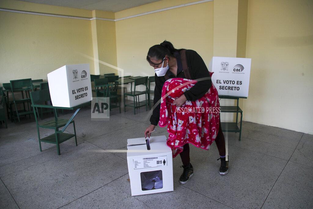 Dolores Ochoa A woman votes during a runoff presidential election in Quito, Ecuador, Sunday, April 11, 2021. (AP Photo/Dolores Ochoa)