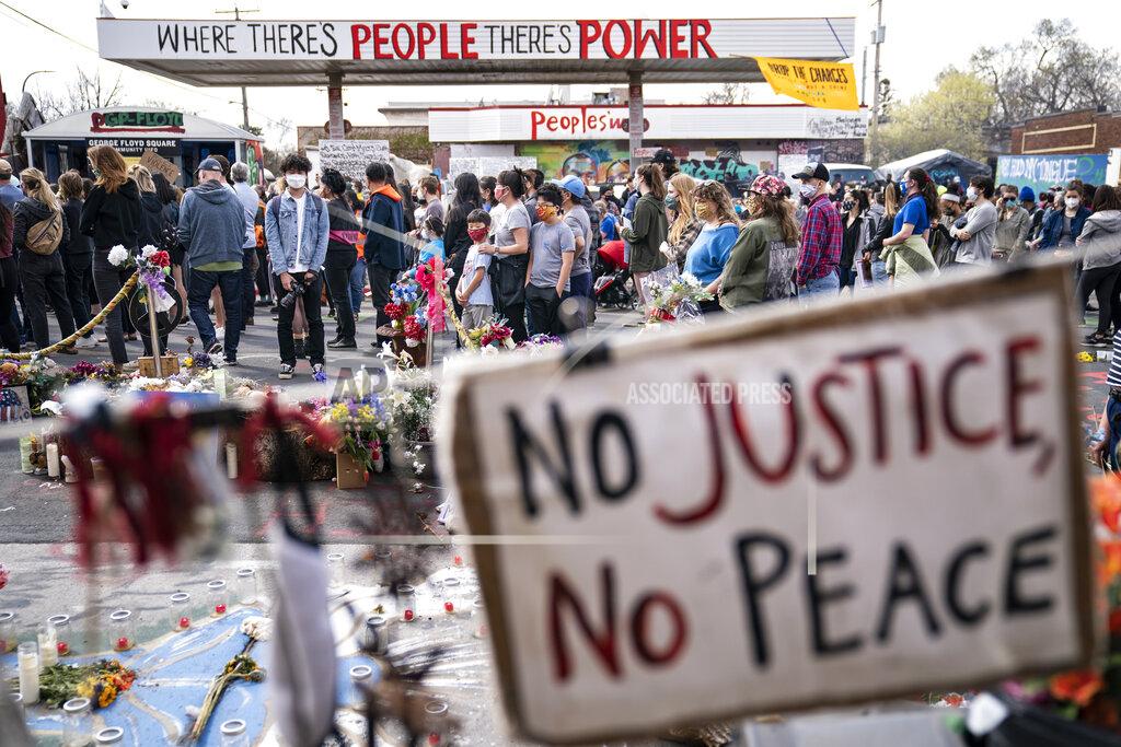 John Minchillo Demonstrators gather for a solidarity rally in memory of the deceased George Floyd and Daunte Wright outside Cup Foods, Sunday, April 18, 2021, in Minneapolis. (AP Photo/John Minchillo)