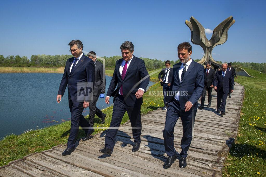 Darko Bandic Croatia's President Zoran Milanovic, center, Prime Minister Andrej Plenkovic, left, and Parliament speaker Gordan Jandrokovic walk away from the monument after laying flowers during a commemoration ceremony for the victims of a World War II camp in Jasenovac, Croatia, Wednesday, April 22, 2020. Representatives of the Croatian Jews, Serbs, Roma and anti-fascists for the first time in years agreed to join top Croatian officials at the ceremony, but warned this was because of the emergency situation over the new coronavirus and could change unless the authorities do more to curb right-wing sentiments in the country. (AP Photo/Darko Bandic)