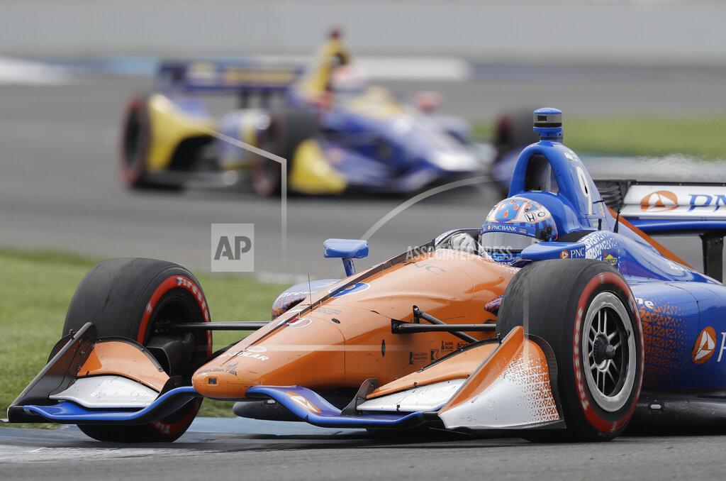 Darron Cummings FILE - In this May 12, 2018, file photo, Scott Dixon, of New Zealand, heads through a turn during the IndyCar Grand Prix auto race at Indianapolis Motor Speedway in Indianapolis. NASCAR and IndyCar have postponed their weekend schedules at Atlanta Motor Speedway and St. Petersburg, Florida, due to concerns over the COVID-19 pandemic. NASCAR also postponed next week's race near Miami and IndyCar suspended the season through the end of April. (AP Photo/Darron Cummings, File)