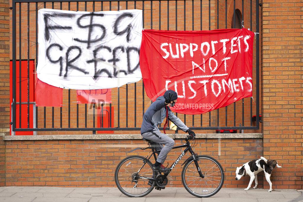 Jon Super Banners are seen outside Liverpool's Anfield Stadium after the collapse of English involvement in the proposed European Super League, Liverpool, England, Wednesday, April 21, 2021. Liverpool owner John W Henry has apologised to the club's supporters for the "disruption" caused by the proposed European Super League (ESL). (AP Photo/Jon Super)