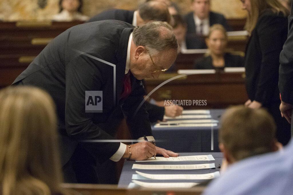 Matt Rourke FILE—In this file photo from Dec. 19, 2016, elector Robert Gleason certifies the results during Pennsylvania's 58th Electoral College at the state Capitol in Harrisburg, Pa., Monday, Dec. 19, 2016. In 2016, the 20 unbound Electoral College members from Pennsylvania gathered in Harrisburg for Republican President-elect Donald Trump under pressure from Democrats to flip their vote to Democrat Hillary Clinton. This year, the 20 unbound Electoral College members from Pennsylvania will gather Monday in Harrisburg for Democratic President-elect Joe Biden, amid efforts by Trump to reverse the election result. (AP Photo/Matt Rourke, File)