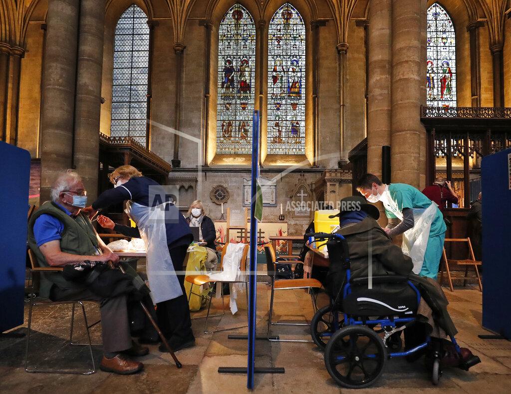 Frank Augstein People recieve their Pfizer-BioNTech vaccination inside Salisbury Cathedral in Salisbury, England, Wednesday, Jan. 20, 2021. Salisbury Cathedral opened its doors for the second time as a venue for the Sarum South Primary Care Network COVID-19 Local Vaccination Service. (AP Photo/Frank Augstein)