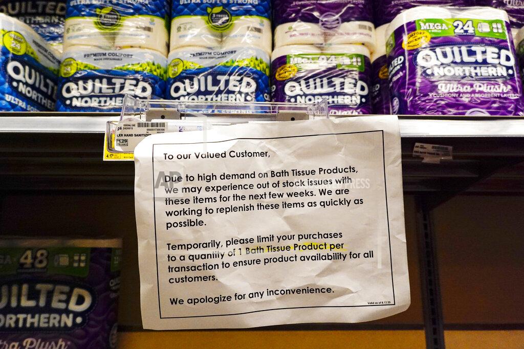 A sign displays limits on the amount of bath tissue that can be purchased at a Kroger Store in Carmel, Ind., Tuesday, Nov. 17, 2020. A surge of new coronavirus cases in the U.S. is sending people back to stores to stockpile again, leaving shelves bare and forcing retailers to put limits on purchases. (AP Photo/Michael Conroy)
