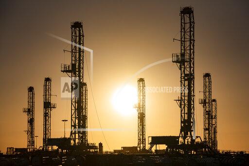 The morning sun rises behind oil rigs sitting in storage Saturday, Feb. 6, 2021 at a yard outside of Odessa, Texas. The OPEC oil cartel and allied countries said Thursday, April 1, 2021 that they have decided to add gradually add back some 2 million barrels per barrel per day of oil production from May to July, moving cautiously in pace with the recovery of the global economy from the COVID-19 pandemic. (Eli Hartman/Odessa American via AP, file)