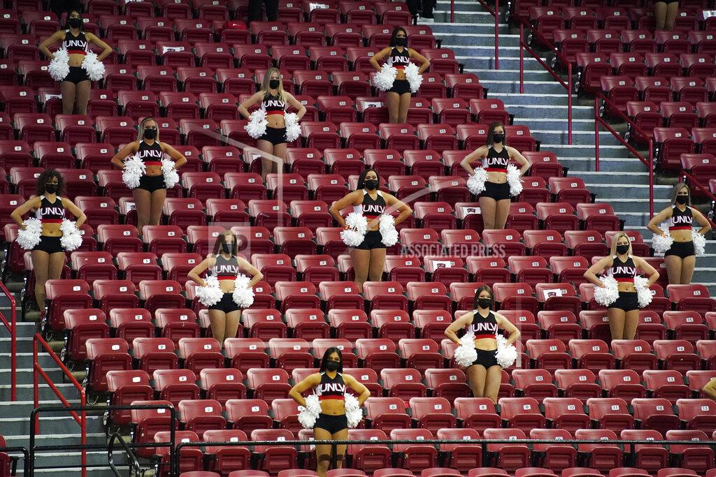 John Locher UNLV cheerleaders in the stands against Fresno State during the second half of an NCAA college basketball game Wednesday, Feb. 24, 2021, in Las Vegas. (AP Photo/John Locher)