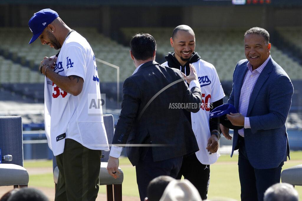 New Los Angeles Dodgers players David Price and Mookie Betts are greeted by Dodger President, Baseball Operations, Andrew Friedman and manager Dave Roberts during a news conference to announce their acquisition at the Dodger Stadium in Los Angeles, Wednesday, Feb. 12, 2020. (AP Photo/Chris Carlson)