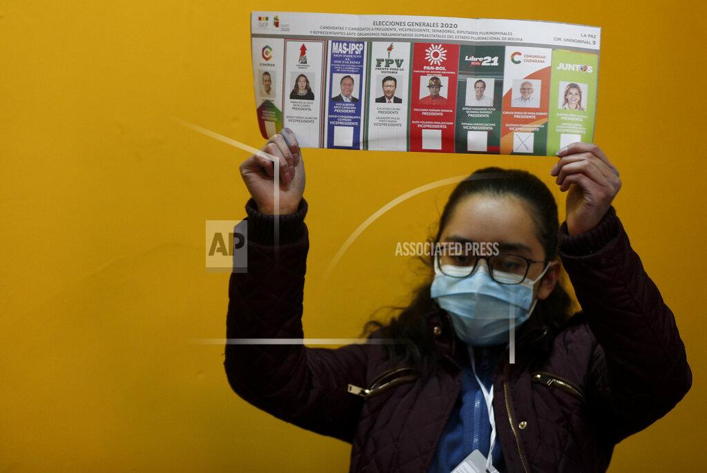 Juan Karita An electoral official holds a ballot as they count votes after polls closed for general elections in La Paz, Bolivia, Sunday, Oct. 18, 2020. (AP Photo/Juan Karita)
