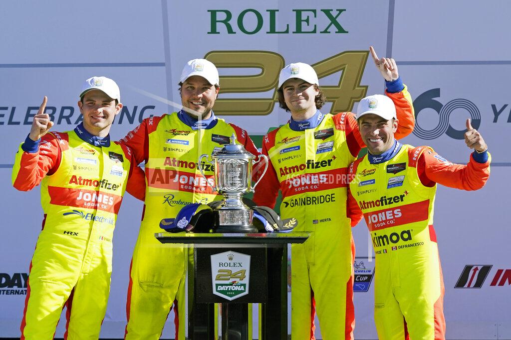 John Raoux Winners of the LeMans Prototype 2 class in the Rolex 24 hour auto race, from left to right, Mexico's Patricio O'Ward, Eric Lux, Devlin Defrancesco and Cotlon Herta pose at Daytona International Speedway, Sunday, Jan. 30, 2022, in Daytona Beach, Fla. (AP Photo/John Raoux)
