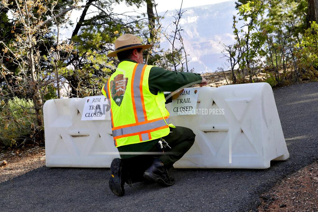 Matt York A Park Ranger blocks off a trail along Rim Drive at the Grand Canyon Friday, May 15, 2020, in Grand Canyon, Ariz. Tourists are once again roaming portions of Grand Canyon National Park when it partially reopened Friday morning, despite objections that the action could exacerbate the coronavirus pandemic.(AP Photo/Matt York)