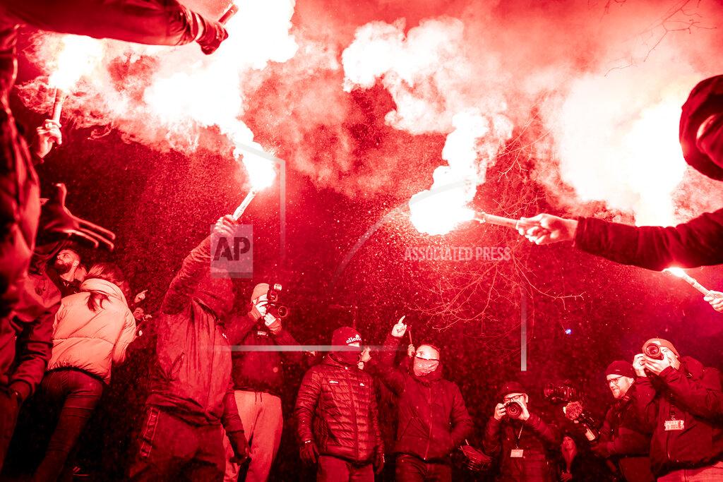 Mads Claus Rasmussen Members of the activist group Men in Black protest in a street against the government's COVID-19 restrictions, in Copenhagen, Saturday, Feb. 27, 2021. (Mads Claus Rasmussen/Ritzau Scanpix via AP)
