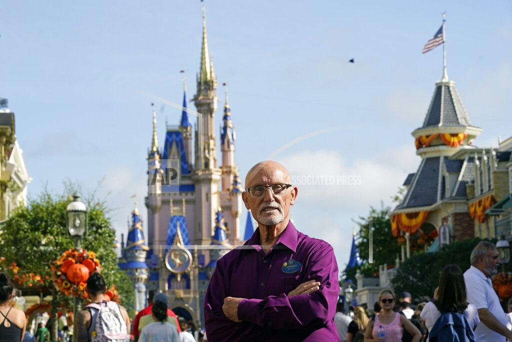 John Raoux Forrest Bahruth stands on Main Street in front of the Cinderella Castle at the Magic Kingdom theme park at Walt Disney World Monday, Aug. 30, 2021, in Lake Buena Vista, Fla. Bahruth has been working at Disney since the opening day in 1971. (AP Photo/John Raoux)