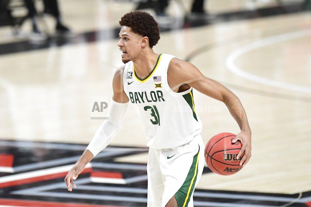 Justin Rex Baylor's MaCio Teague (31) controls the ball during the first half of an NCAA college basketball game against Texas Tech in Lubbock, Texas, Saturday, Jan. 16, 2021. (AP Photo/Justin Rex)