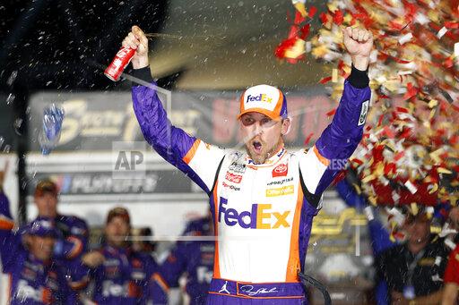 NASCAR Cup Series driver Denny Hamlin (11) celebrates in victory lane after winning a NASCAR Cup Series auto race at the Las Vegas Motor Speedway Sunday, Sept. 26, 2021, in Las Vegas. (AP Photo/Steve Marcus)
