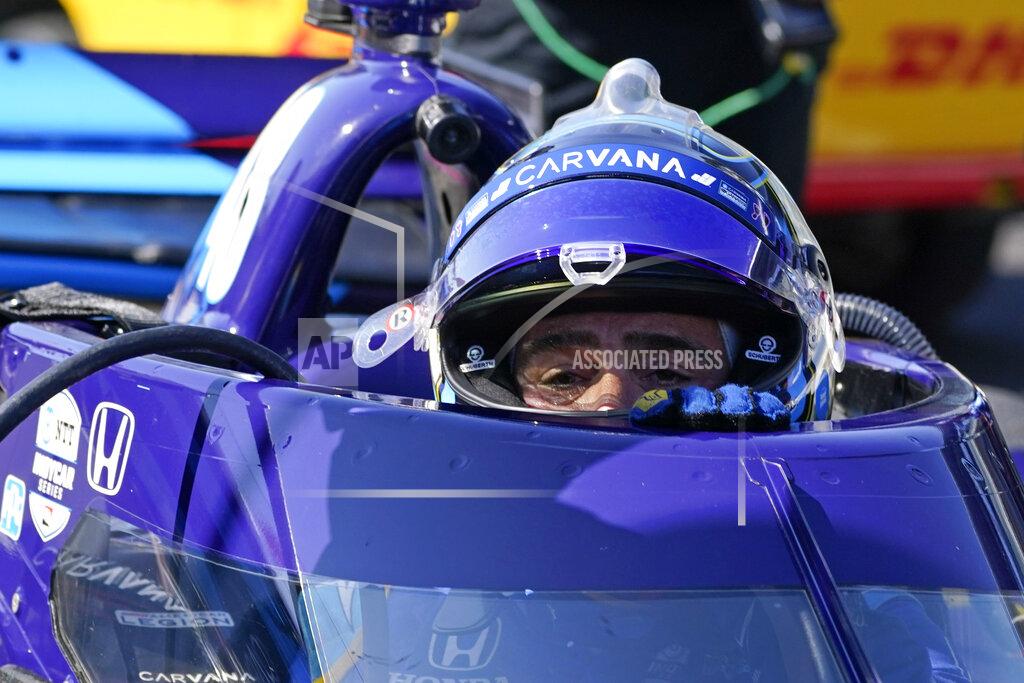 Darron Cummings Jimmie Johnson climbs out of his car following practice for the IndyCar auto race at Indianapolis Motor Speedway, Friday, May 14, 2021, in Indianapolis. (AP Photo/Darron Cummings)
