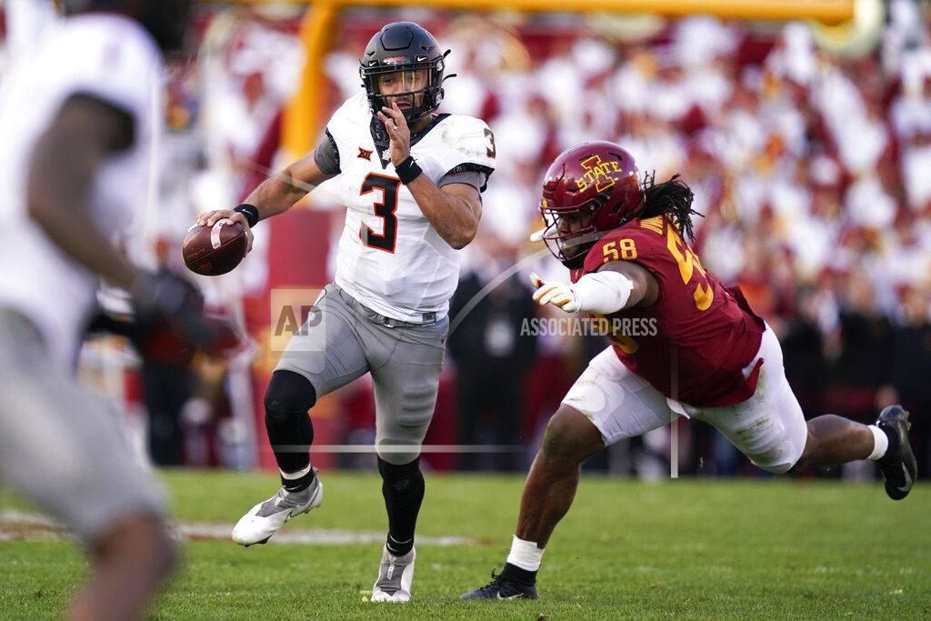 Charlie Neibergall Oklahoma State quarterback Spencer Sanders (3) runs from Iowa State defensive end Eyioma Uwazurike (58) during the second half of an NCAA college football game, Saturday, Oct. 23, 2021, in Ames, Iowa. Iowa State won 24-21. (AP Photo/Charlie Neibergall)