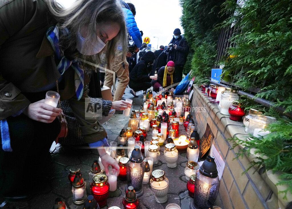 Czarek Sokolowski FILE - In this Monday, Sept. 20, 2021 file photo, Warsaw residents place candles before the national Border Guards Headquarters in Warsaw, Poland, as a sign of mourning for four migrants found dead over the weekend along the border between Poland and Belarus. Two United Nations agencies requested access Tuesday Sept. 21, 2021, to asylum-seekers stranded at Belarus's border with Poland and Lithuania, after four migrants were found dead in the area. (AP Photo/Czarek Sokolowski, File)