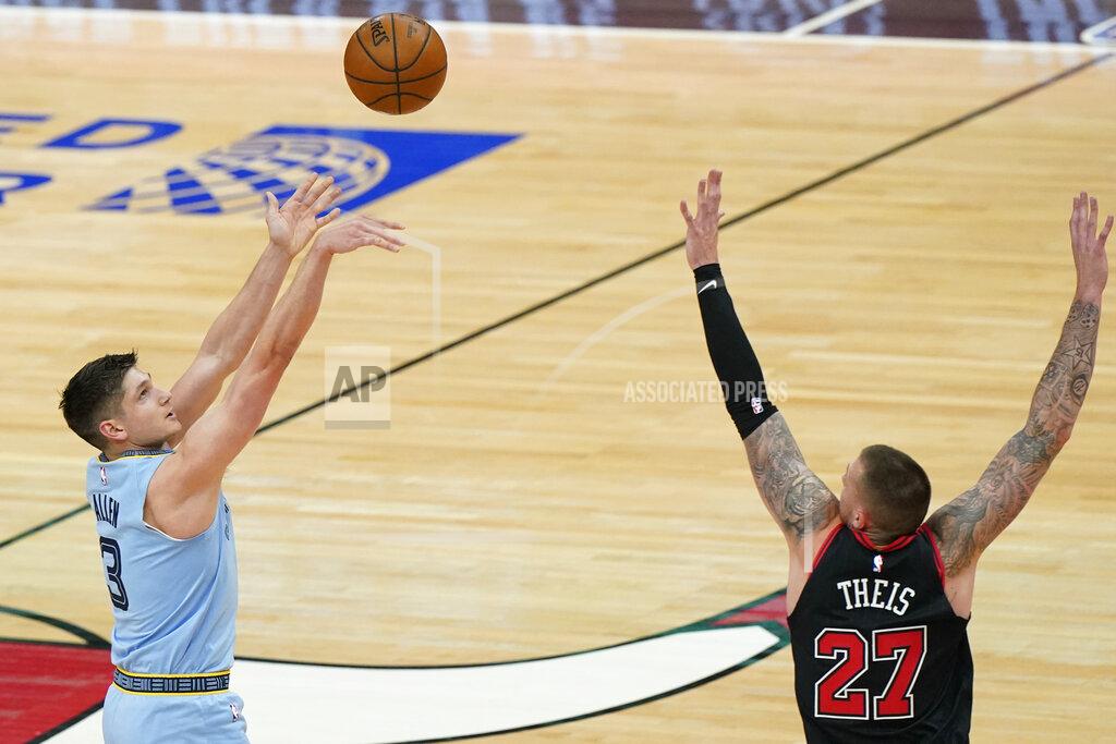 Nam Y. Huh Memphis Grizzlies guard Grayson Allen, left, shoots against Chicago Bulls center Daniel Theis during the first half of an NBA basketball game in Chicago, Friday, April 16, 2021. (AP Photo/Nam Y. Huh)